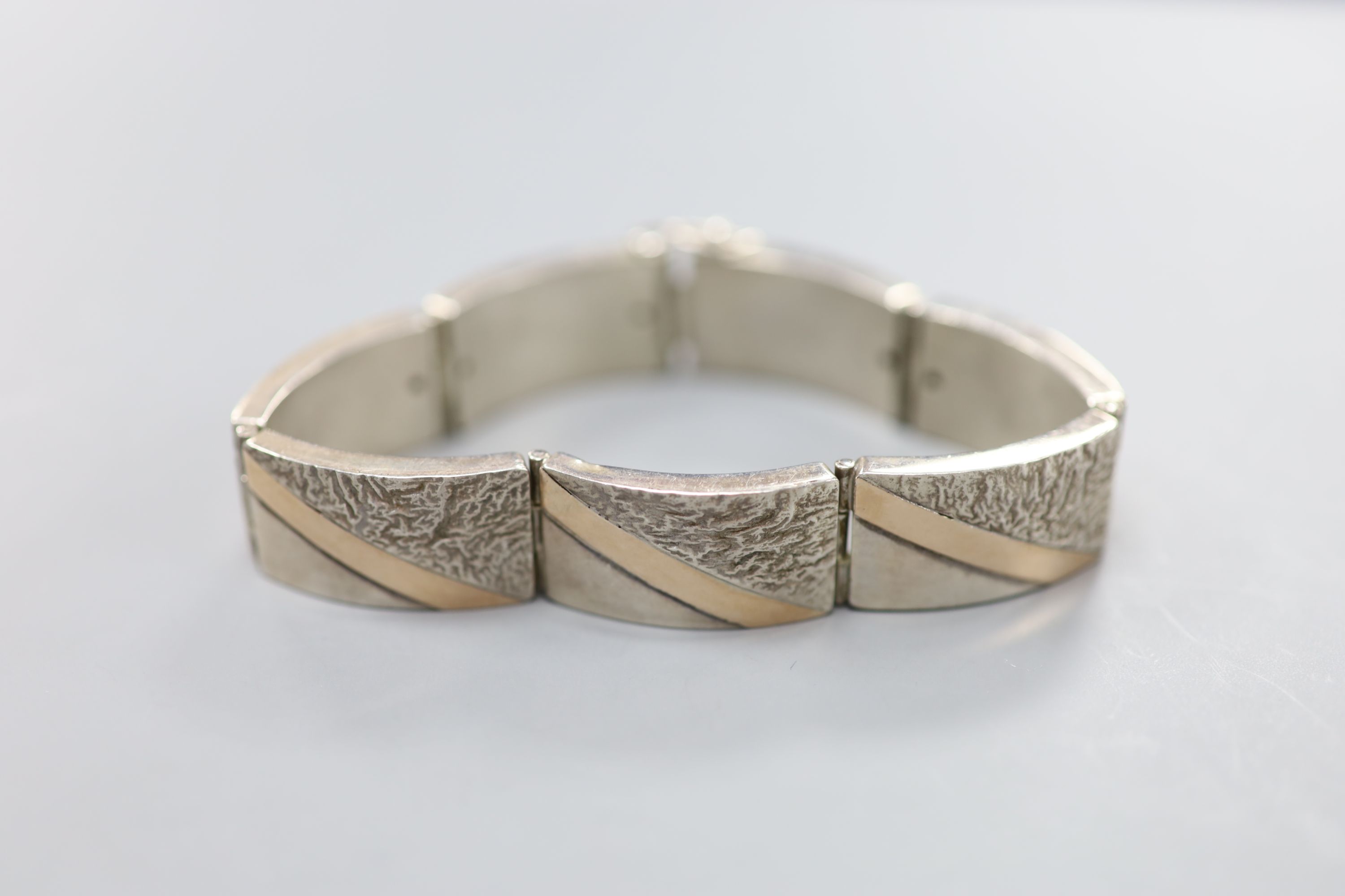 A 20th century white and yellow metal (stamped 925 & 375) demi-lune link bracelet, 21cm, gross 50.9 grams.